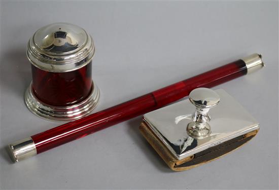 A George V silver mounted ruby glass desk rule, a silver mounted ruby glass pounce pot? and a silver mounted desk blotter.